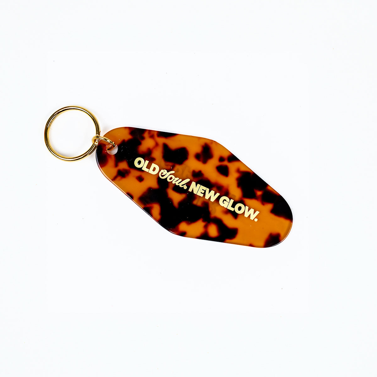 Tortoiseshell keychain with 'Old Soul, New Glow' text on a white background