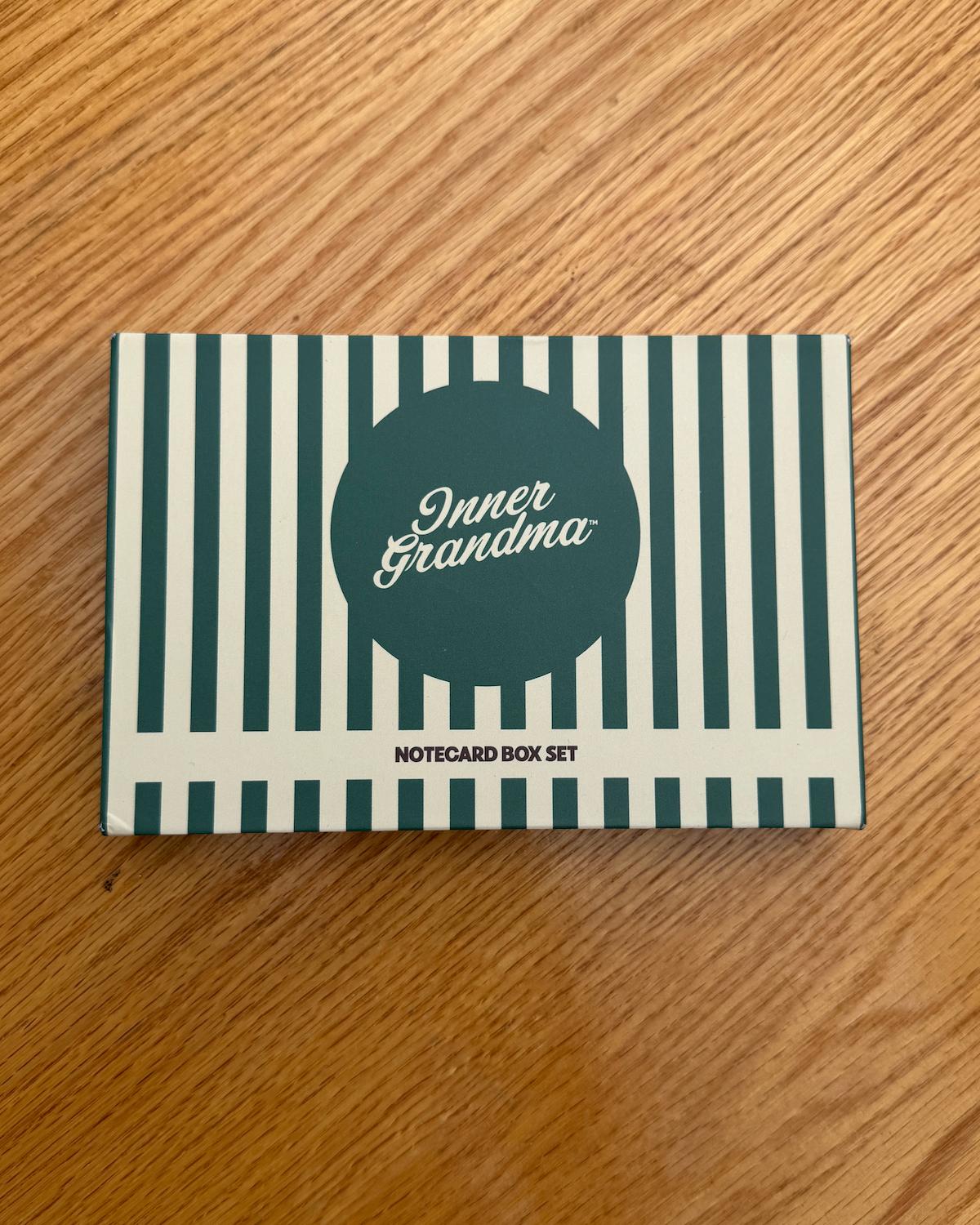 Notecard box set with striped design and 'Inner Grandma' text on a wooden surface