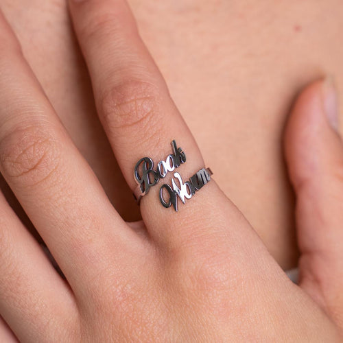 Silver ring with 'Beach Bum' engraving on a person's finger