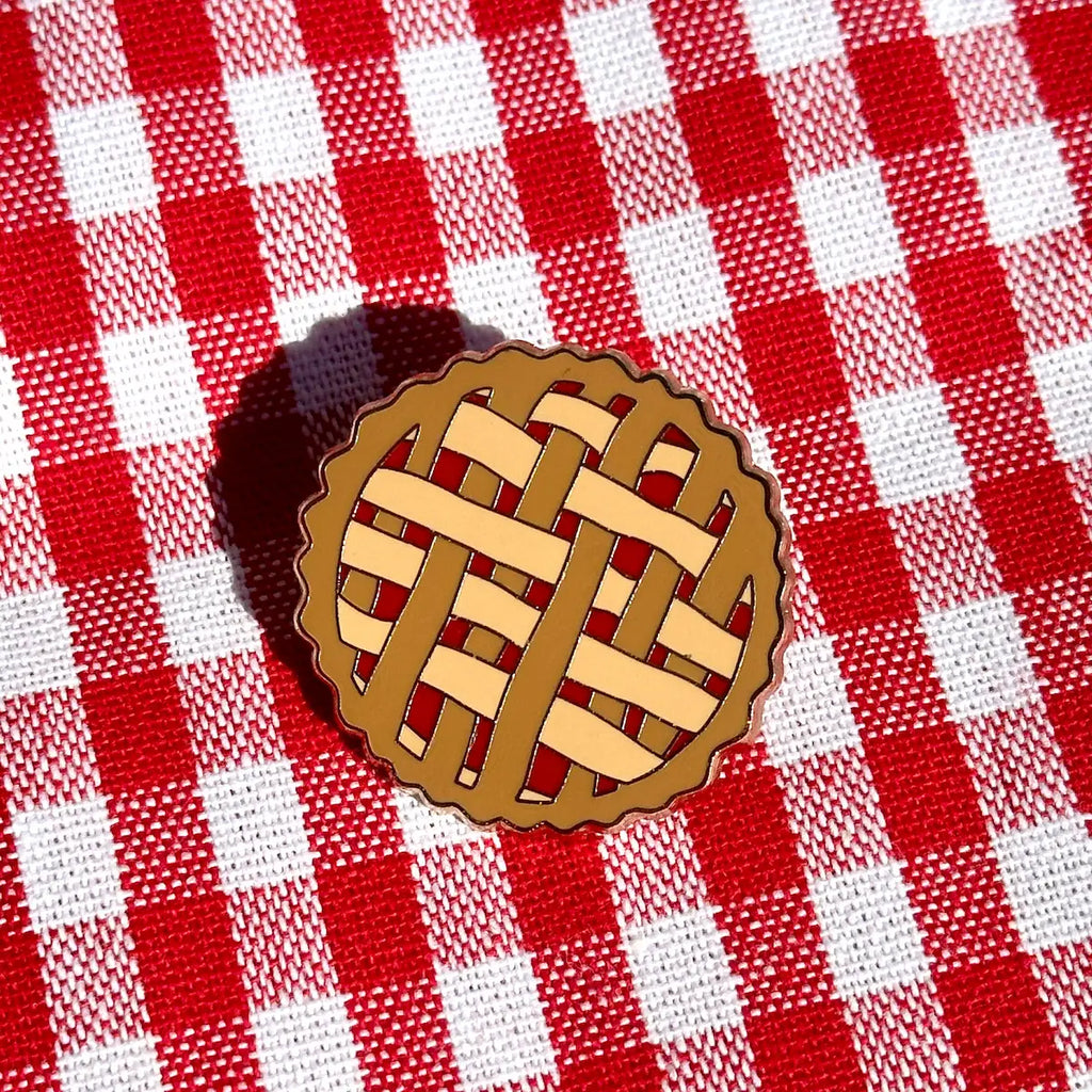 Pie crust pin design on a red and white checkered fabric background