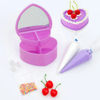 Purple heart-shaped jewelry box with cake decorating tools on a white background