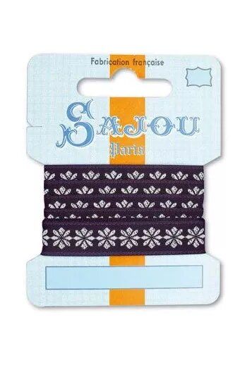 Sajou brand packaging with a purple ribbon with white floral pattern on a light blue card.