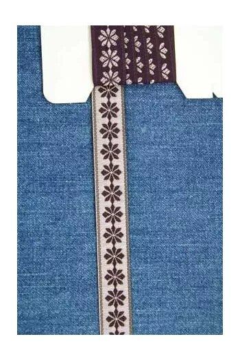Blue fabric with a decorative purple and white pattern on a white background