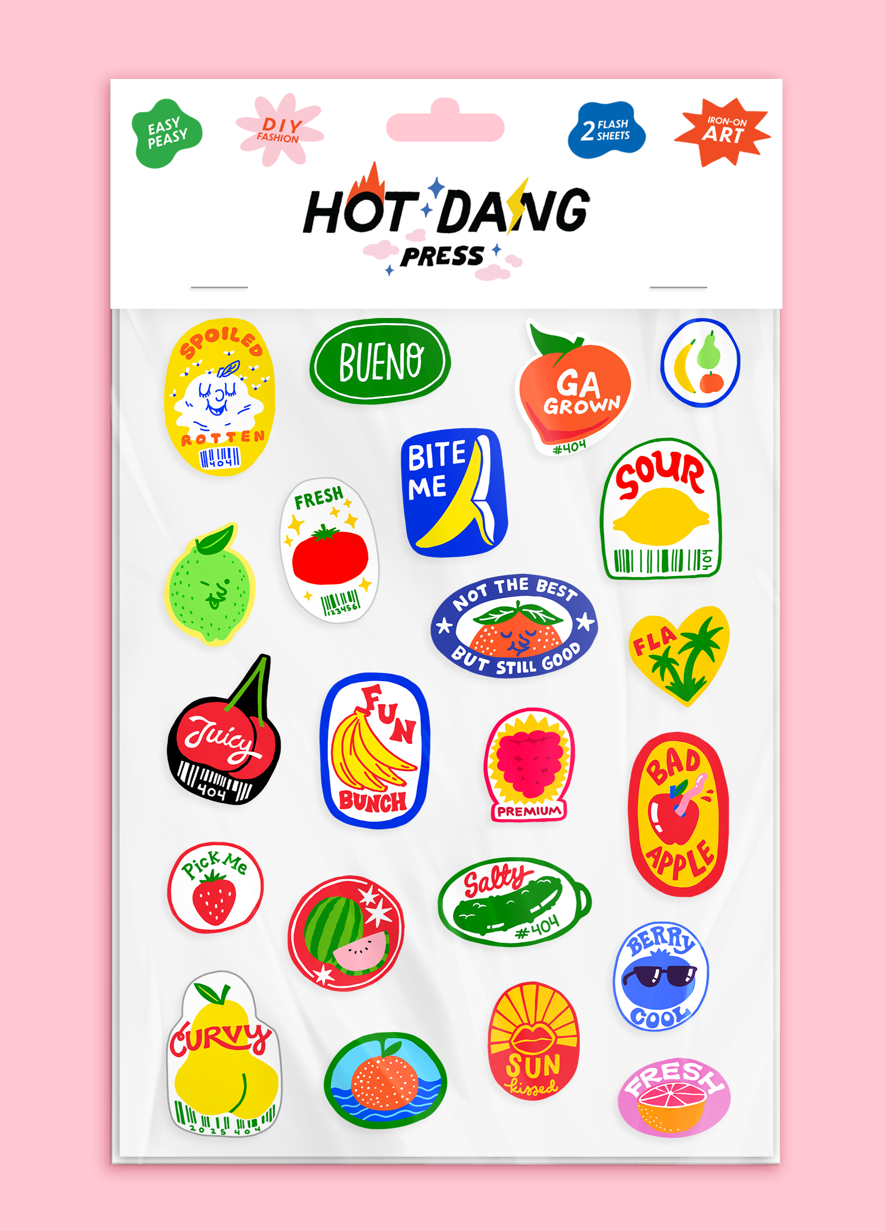 Sheet of colorful iron on fabric stickers with various fruit themed designs on a pink background
