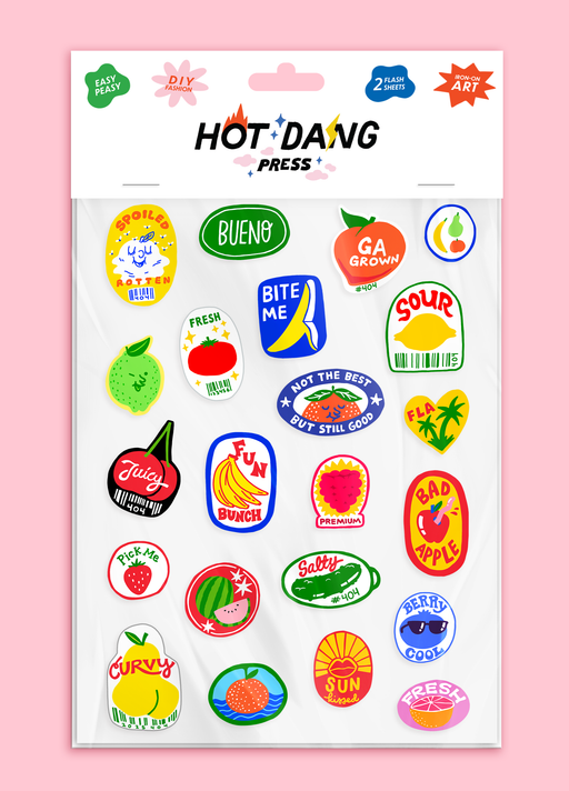 Sheet of colorful iron on fabric stickers with various fruit themed designs on a pink background