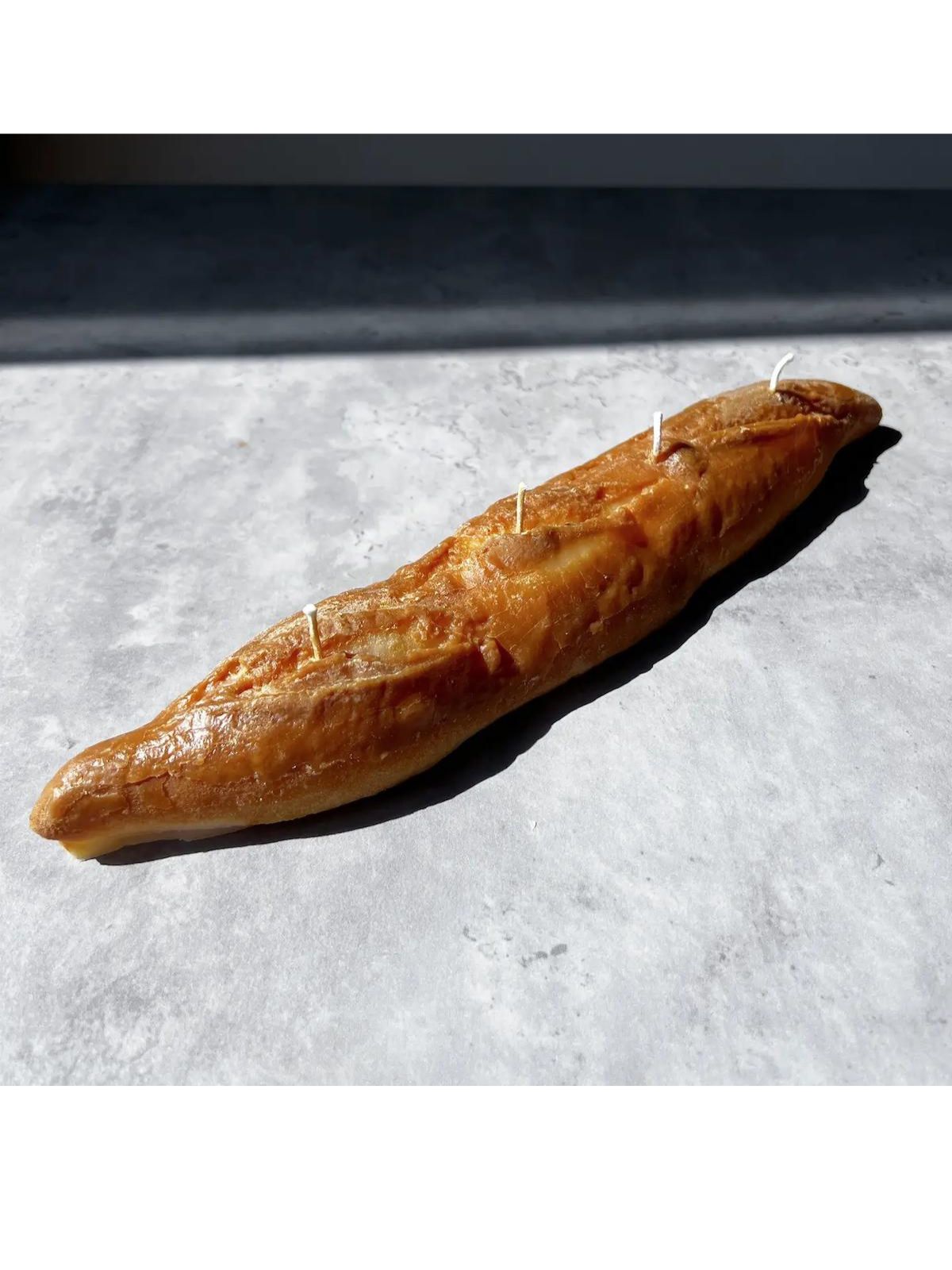 Long loaf of bread on a gray surface