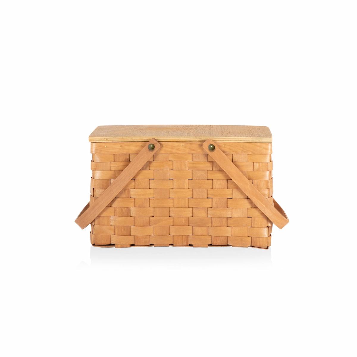 Woven picnic basket with wicker straps on a white background