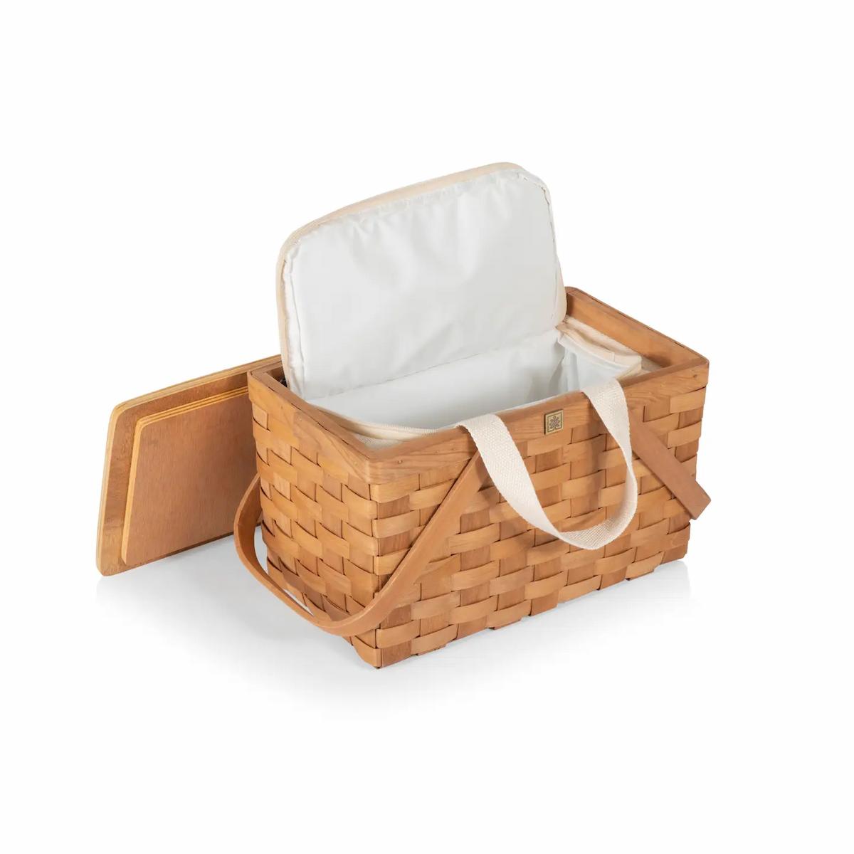 Woven picnic basket with white liner on a white background