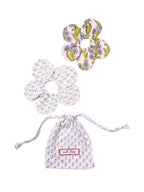 Floral-patterned butterfly earrings with a matching drawstring bag on a white background