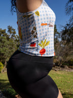 Person wearing a colorful checkered shirt with floral patterns outdoors