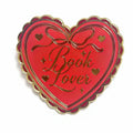 Heart-shaped red and gold enamel pin with 'Book Lover' text on a white background