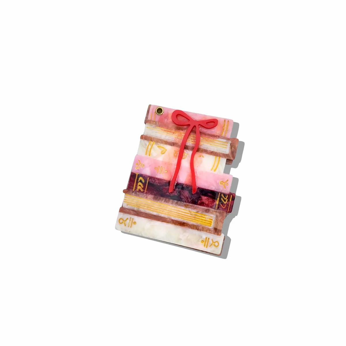 Stack of books tied with a red ribbon on a white background