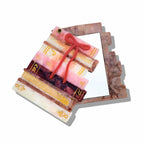 Decorative item resembling a stack of books with a red ribbon on a white background