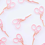 Sarah Hearts pink Iron-on scissors patch with a white background