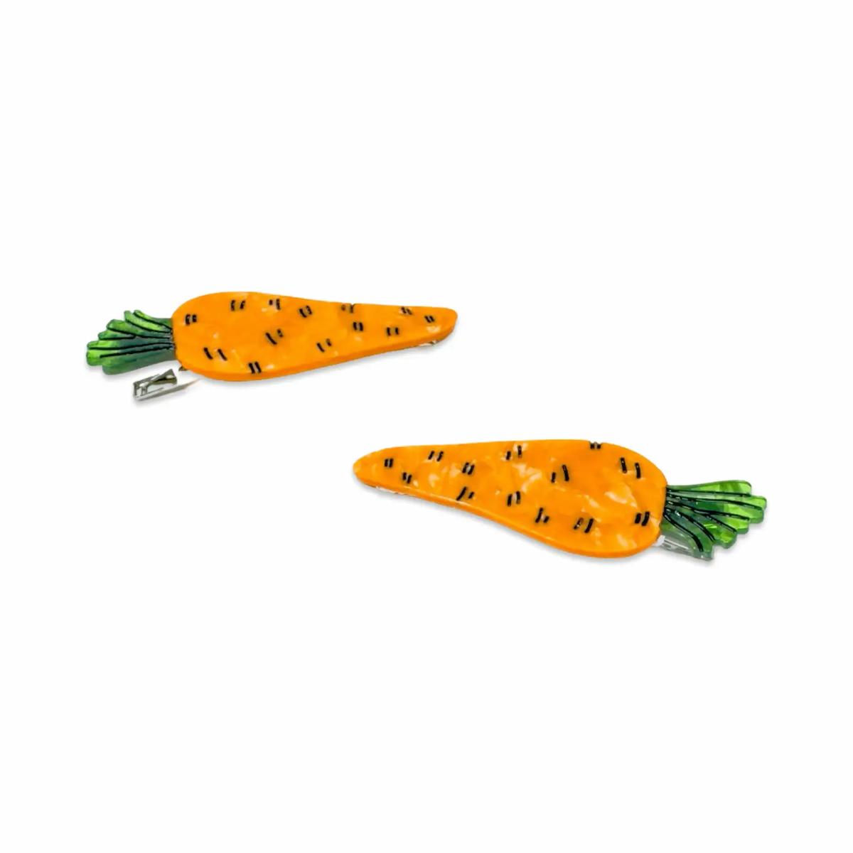 Two carrot-shaped hair clips on a white background