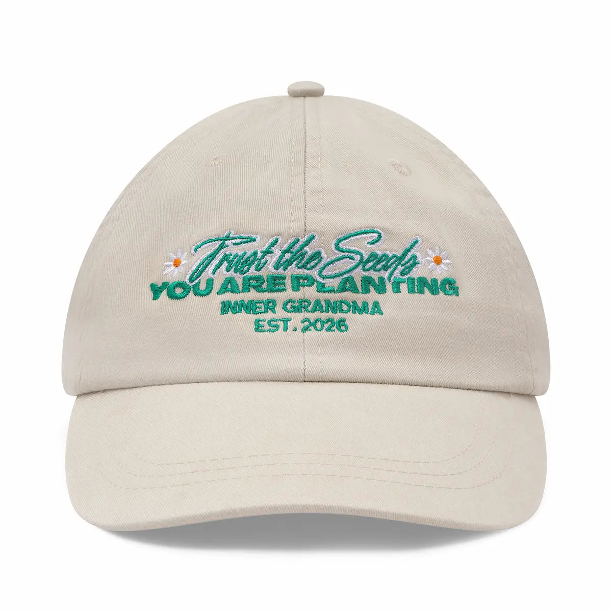 Beige cap with embroidered text and floral designs on a white background