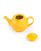 Yellow teapot with a matching lid on a white background