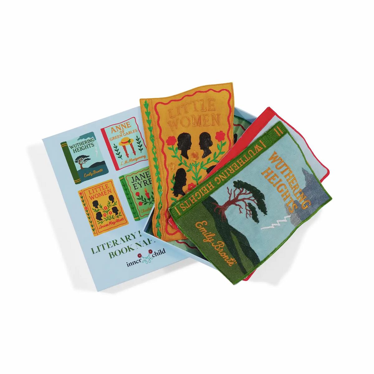 Set of fabric books with literary designs on a white background