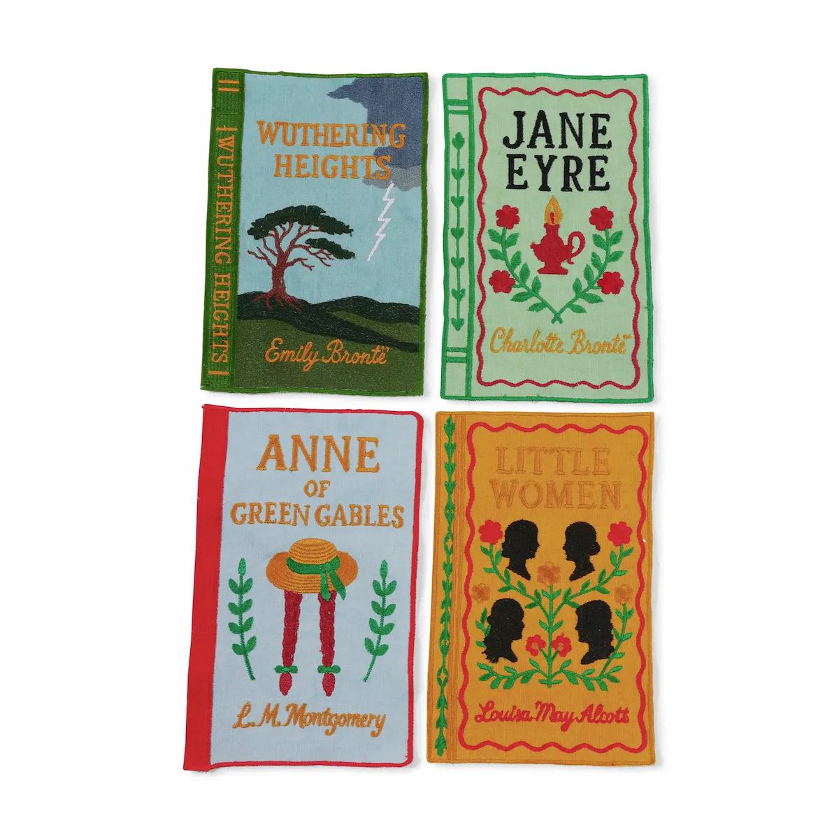 Four book-themed napkins with classic literature covers on a white background.