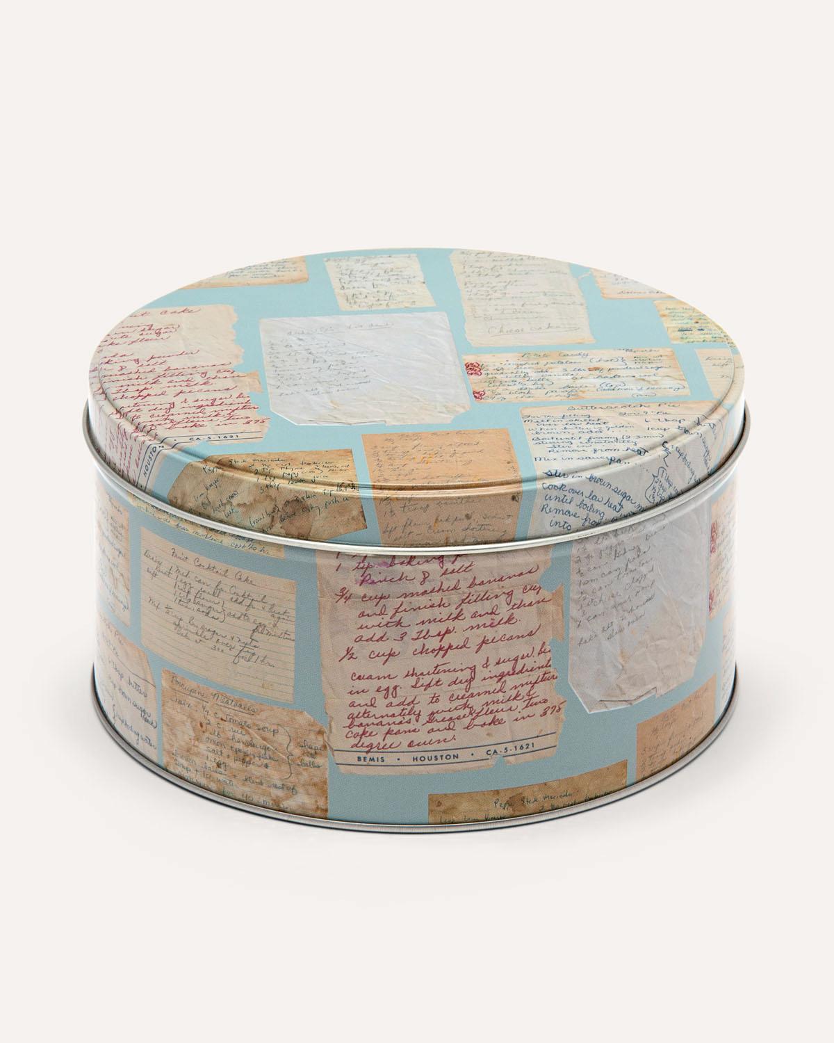 Cookie jar tin box with vintage letter pattern on a white background