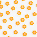 Pattern of small orange flowers on a white background