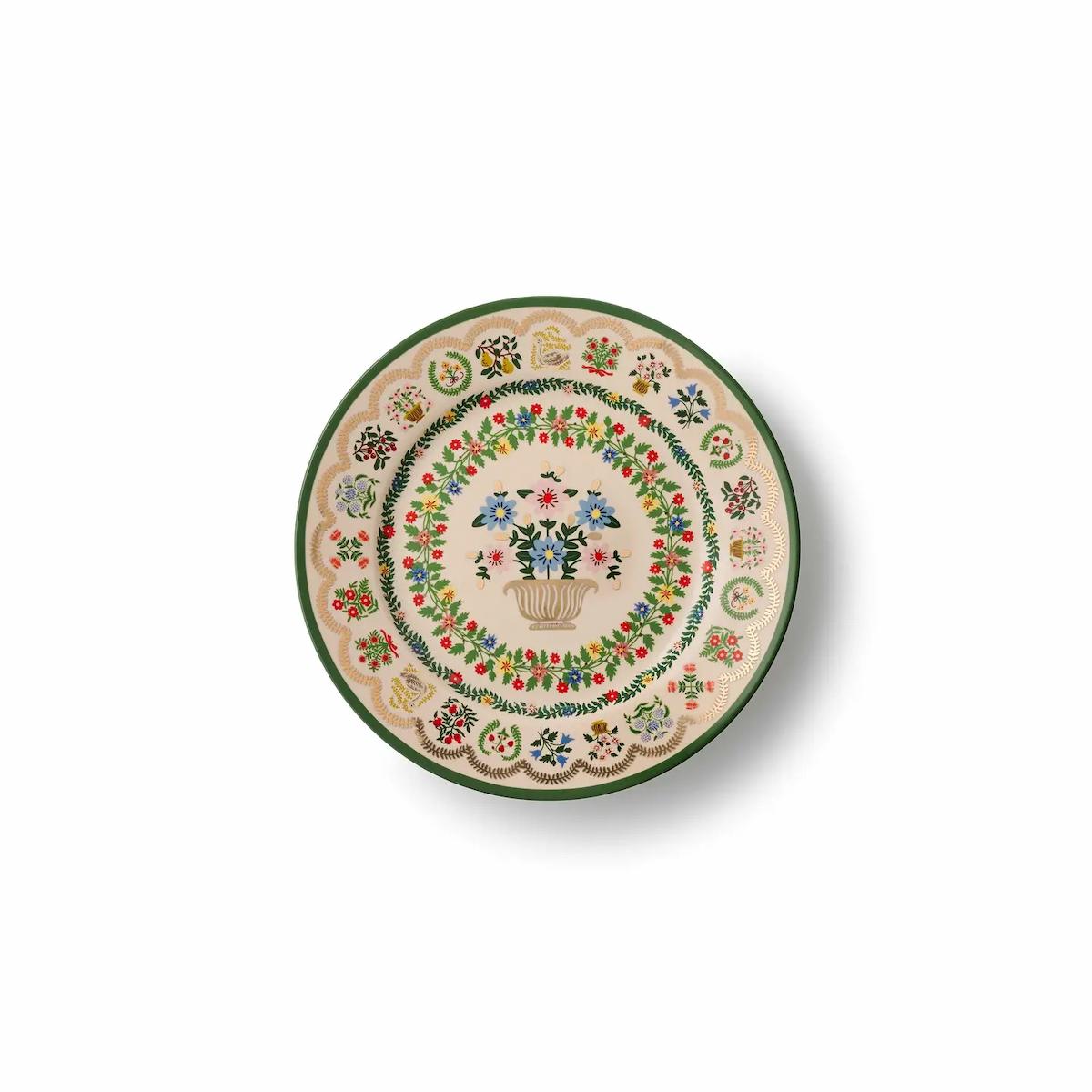 Decorative ceramic plate with floral and leaf patterns on a white background