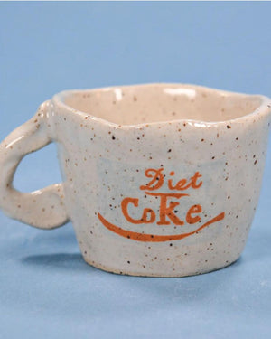 white speckled cup with diet coke logo