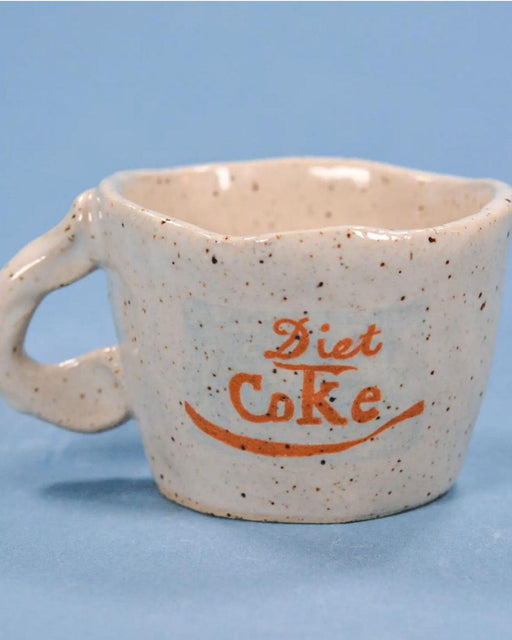 white speckled cup with diet coke logo