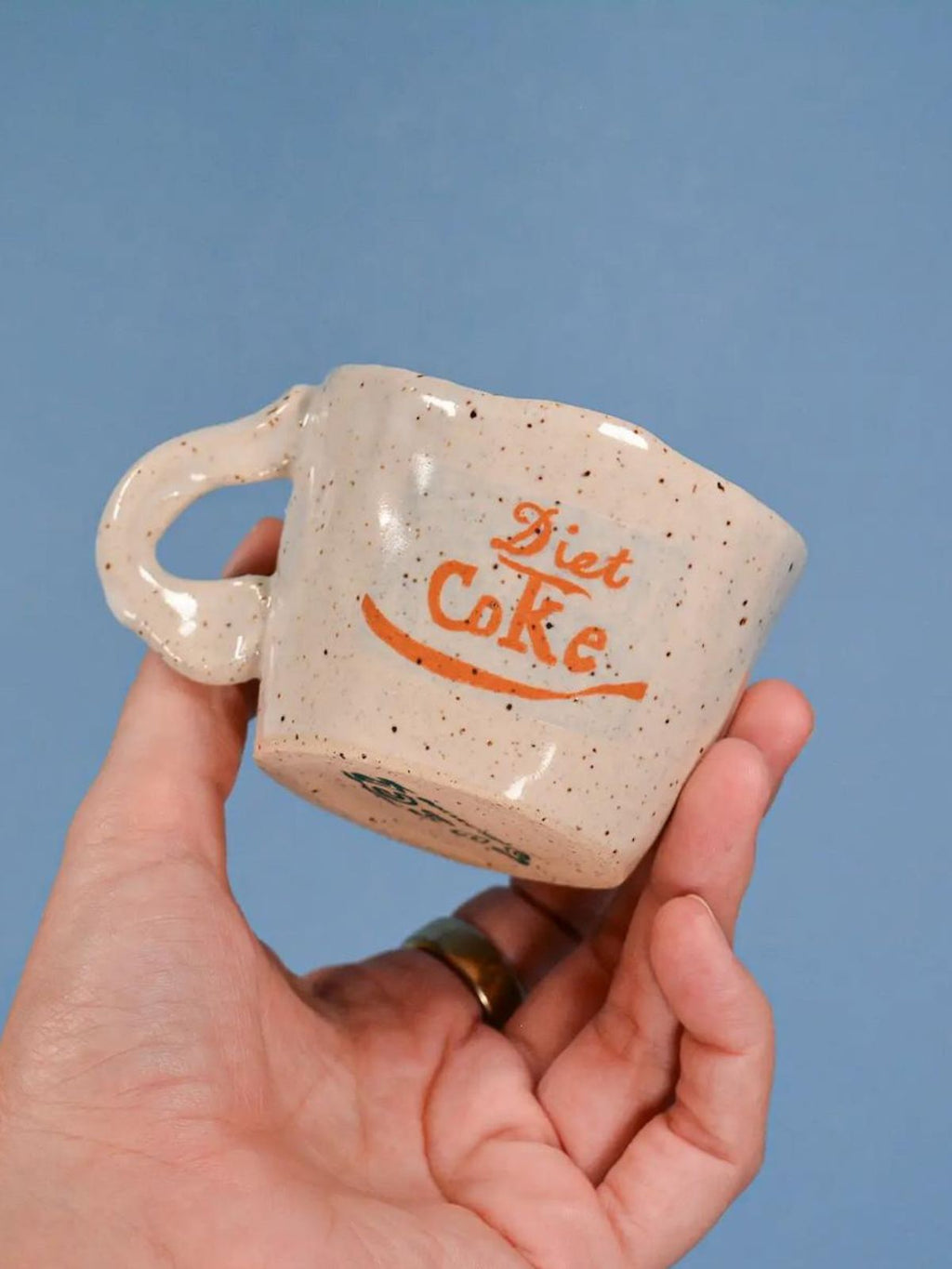 speckled coffee cup with blue background