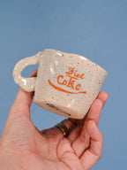 speckled coffee cup with blue background
