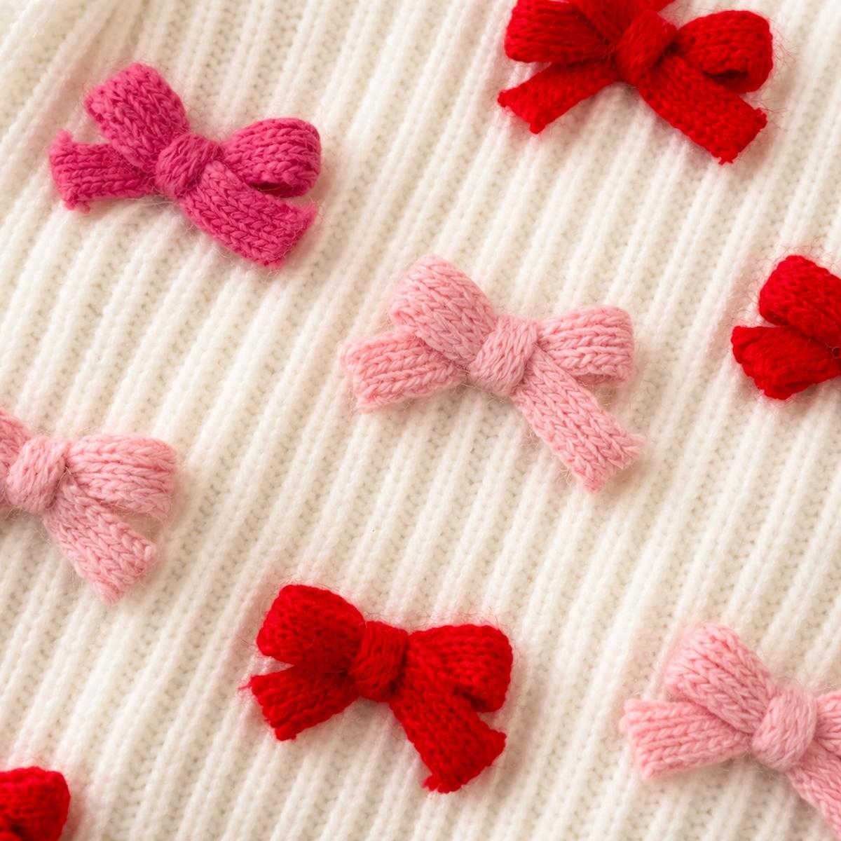 Knitted bows in red and pink on a textured beige background