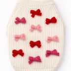 White textured surface with red and pink bows arranged in a pattern