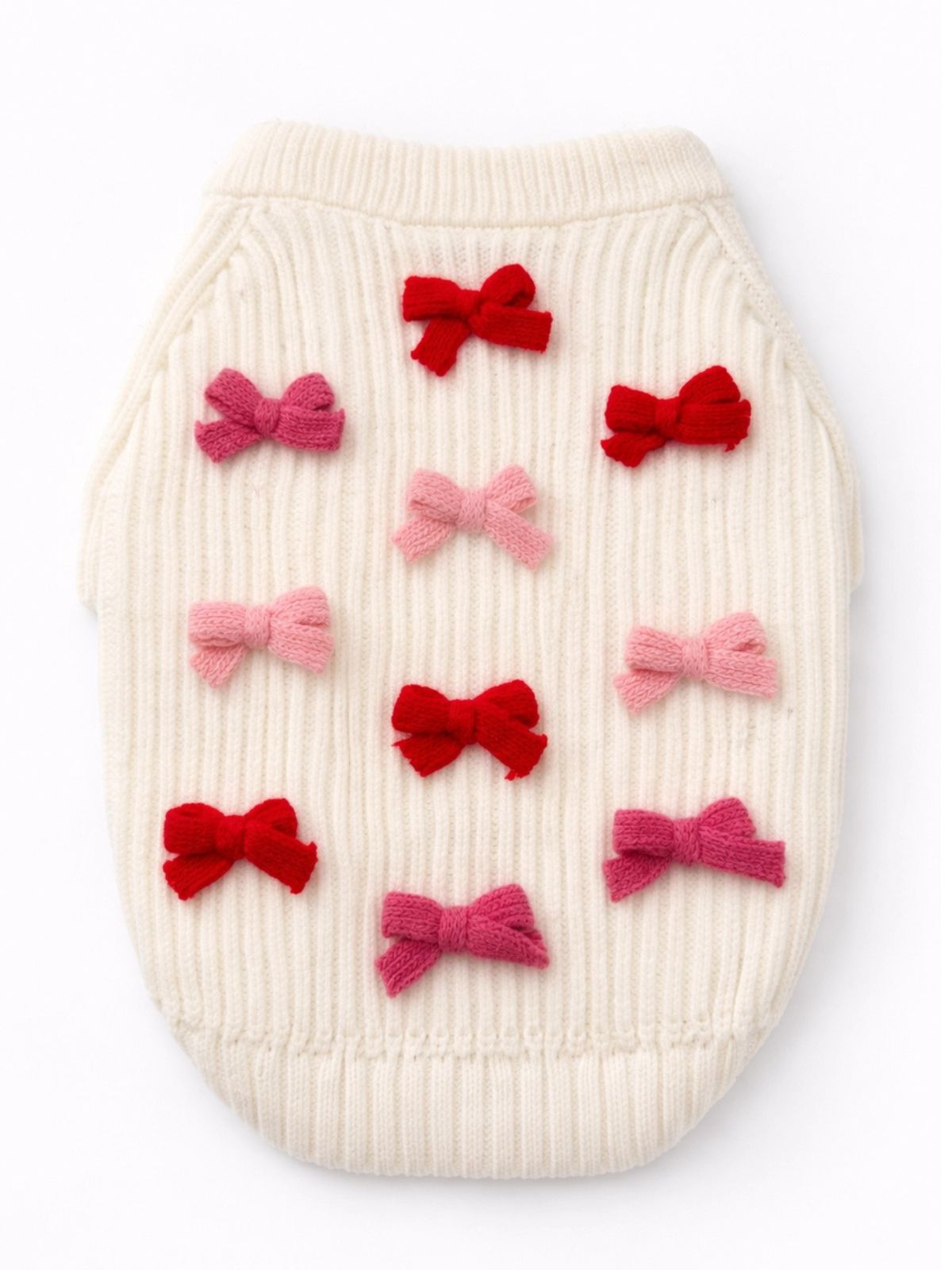 White knitted pet sweater with red and pink bow decorations on a white background
