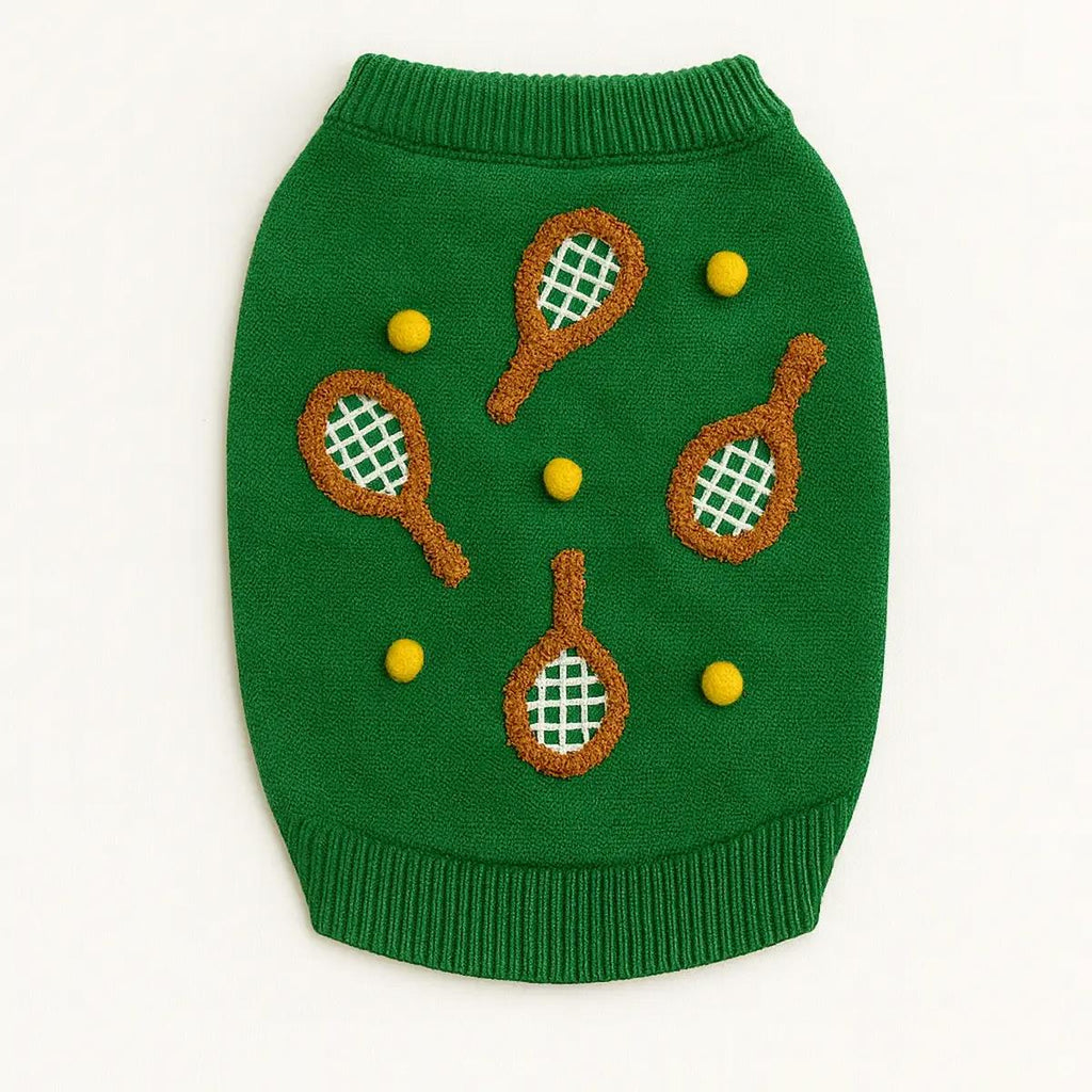 Green dog sweater with tennis racket and ball patterns on a white background