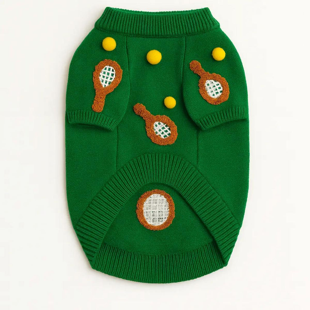 Green dog sweater with tennis ball and racket designs on a white background