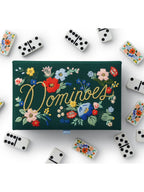 Domino set with floral design on a green box against a white background