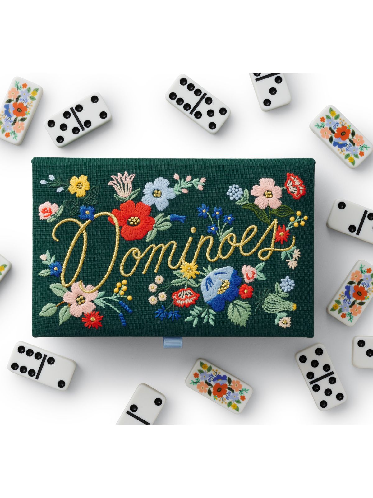 Domino set with floral design on a green box against a white background