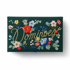 Dark green clutch with floral embroidery and 'Dominoes' text on a white background
