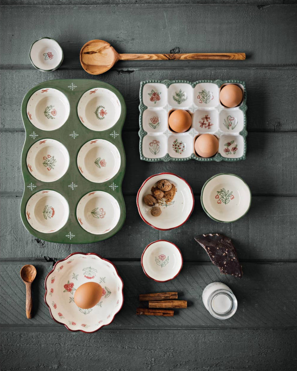 Collection of ceramic dishes and kitchen items on a dark wooden surface