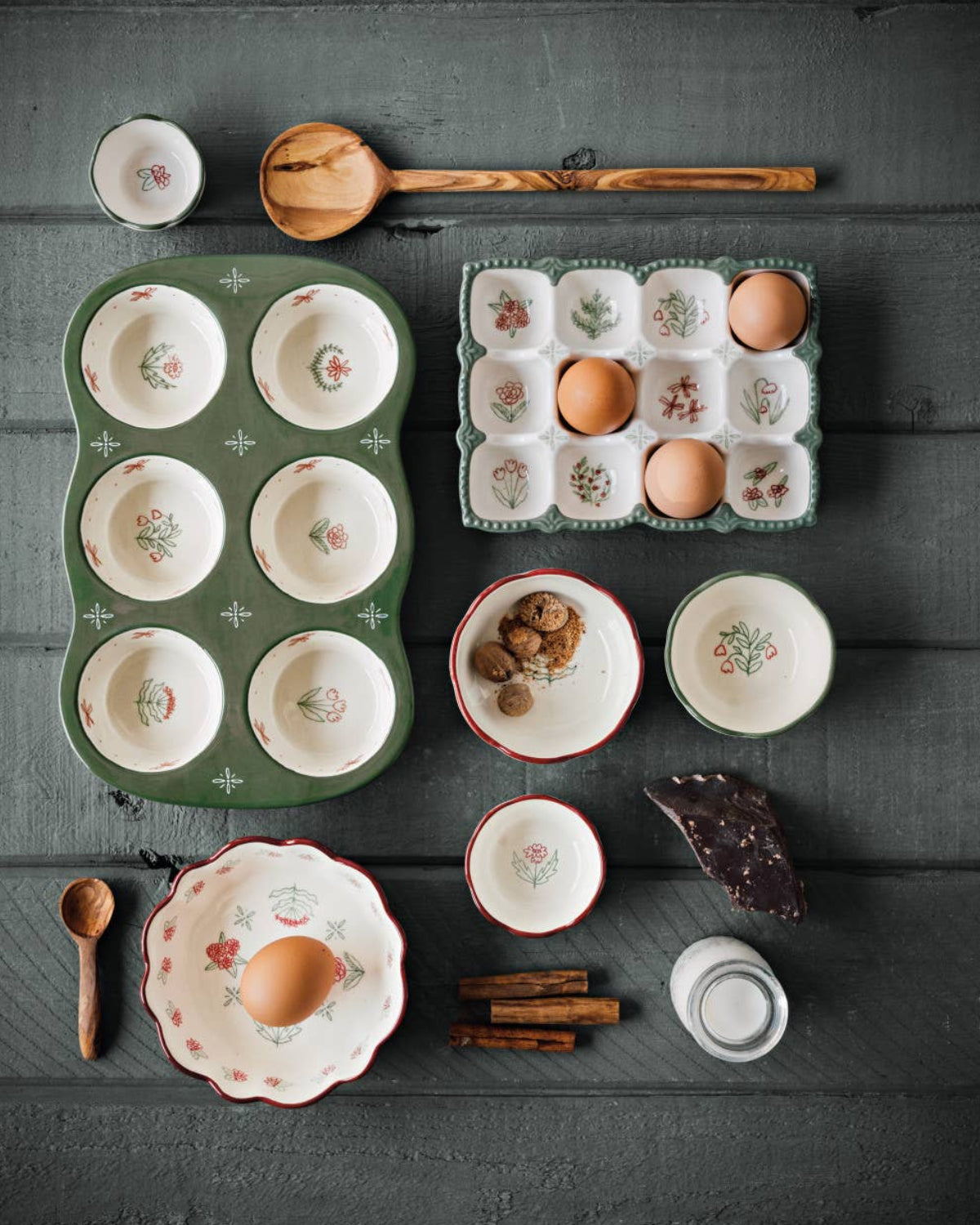 Collection of ceramic dishes and kitchen items on a dark wooden surface