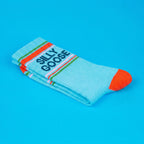 Light blue sock with orange accents and 'SILLY GOOSE' text on a blue background