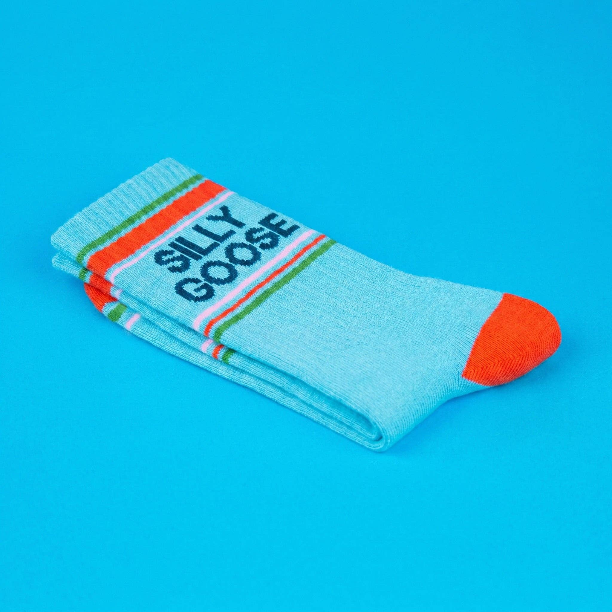 Light blue sock with orange accents and 'SILLY GOOSE' text on a blue background