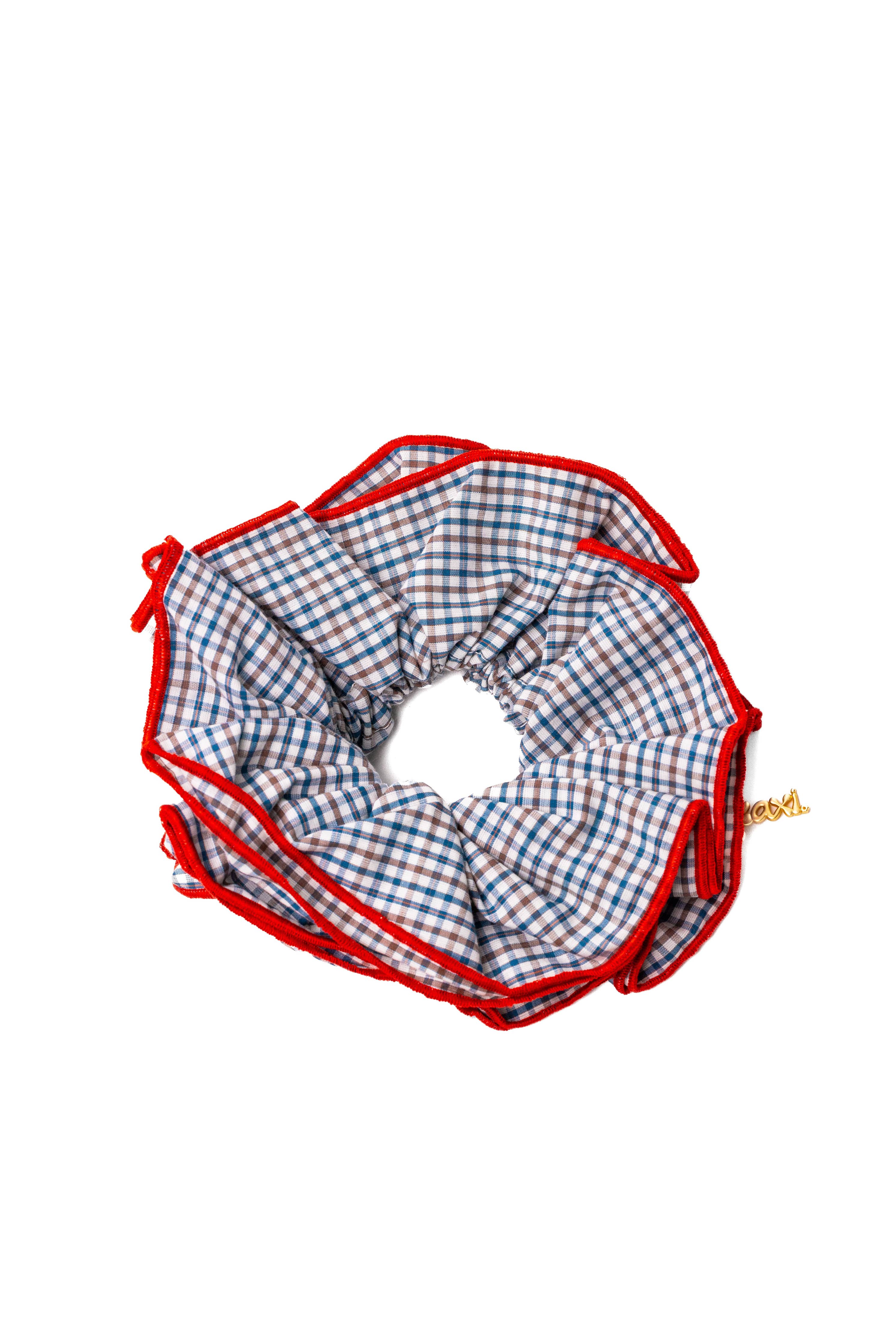 Checkered blue scrunchie with red border on a white background