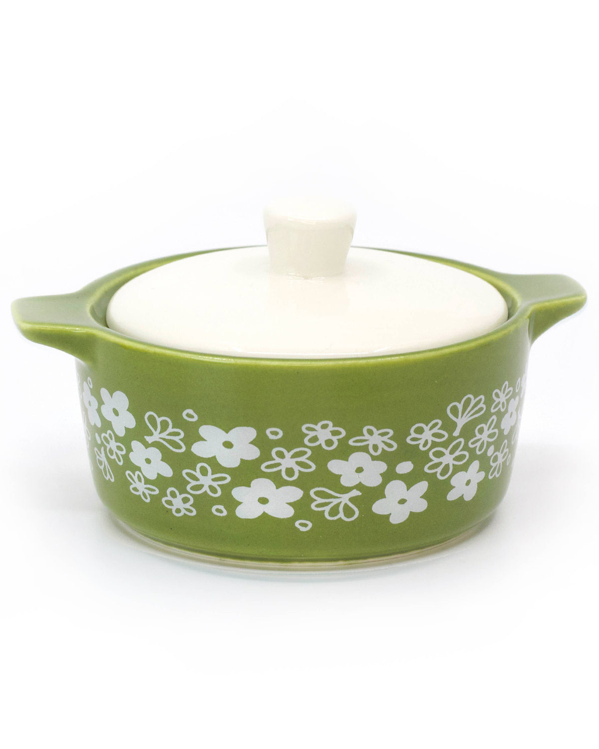 A green ceramic lidded casserole dish inspired trinket box with a white floral pattern on the side and a white lid, shown on a white background.