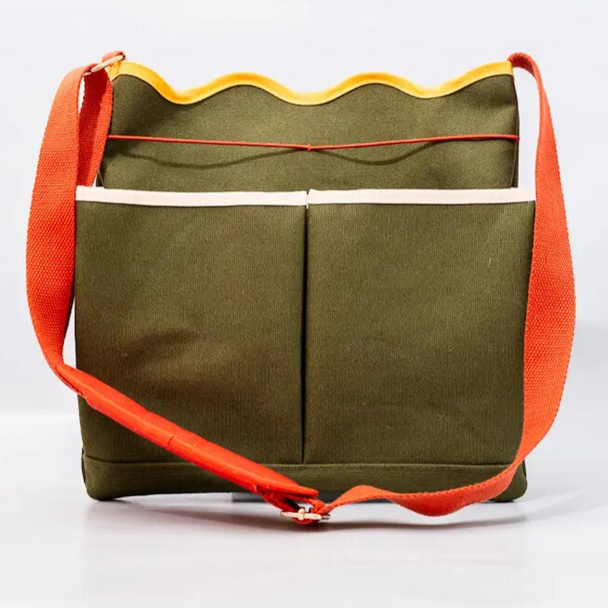 Green bag with orange straps on a white background