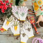 Gardening gloves with plant designs on a wooden surface with gardening tools and plants.