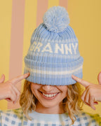 Person wearing a blue beanie with 'GRANNY' text against a striped background