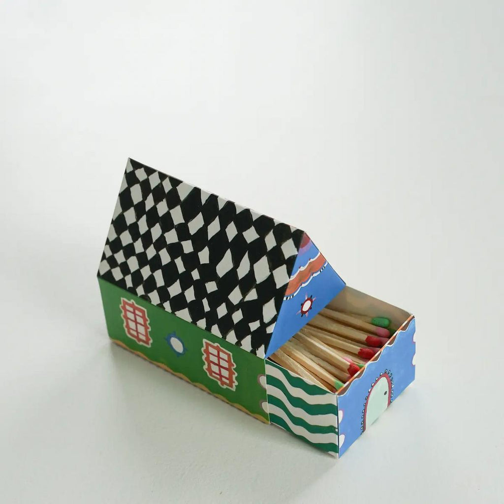 Matches in a colorful matchbox with a checkered lid on a white background