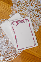 Bow Card on a set of doily on a wood table