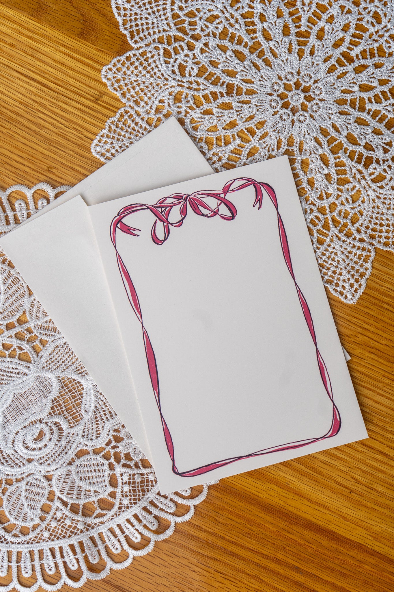 Bow Card on a set of doily on a wood table